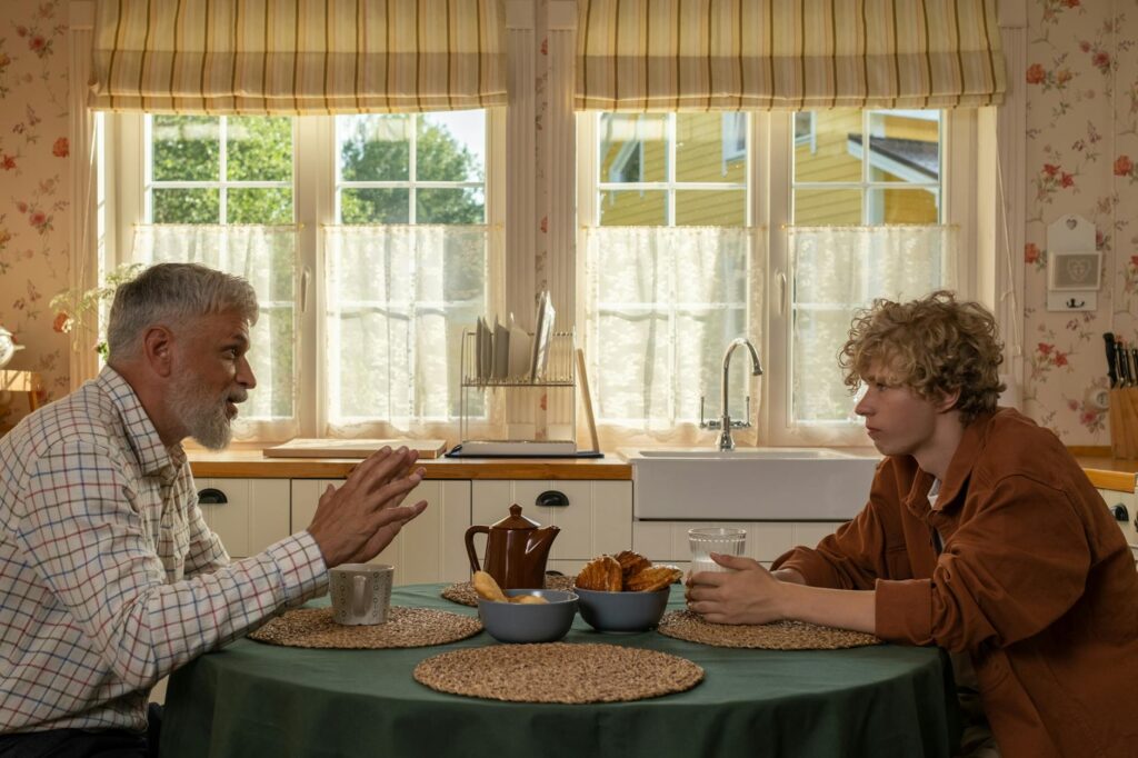 grandfather and grandson talking in kitchen